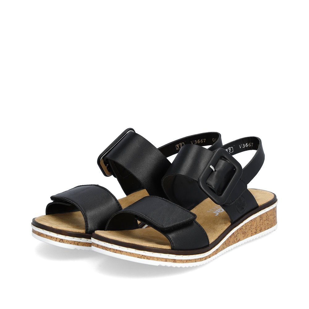 Black Rieker women´s wedge sandals V3667-00 with a hook and loop fastener. Shoes laterally.