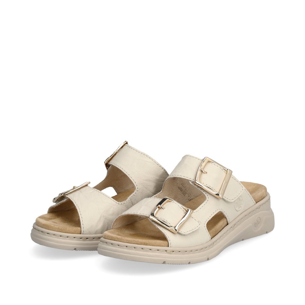 Beige Rieker women´s mules V9254-60 with a hook and loop fastener. Shoes laterally.