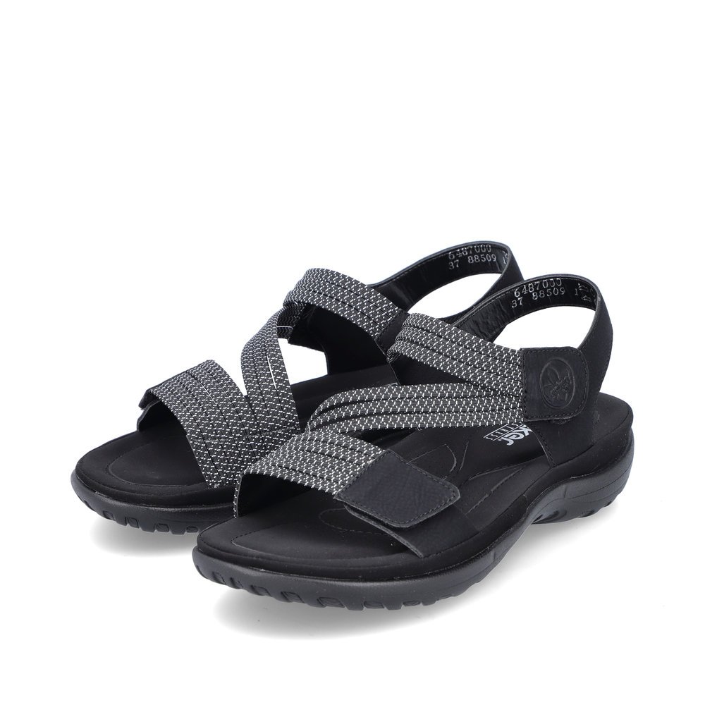Black Rieker women´s strap sandals 64870-00 with a hook and loop fastener. Shoes laterally.