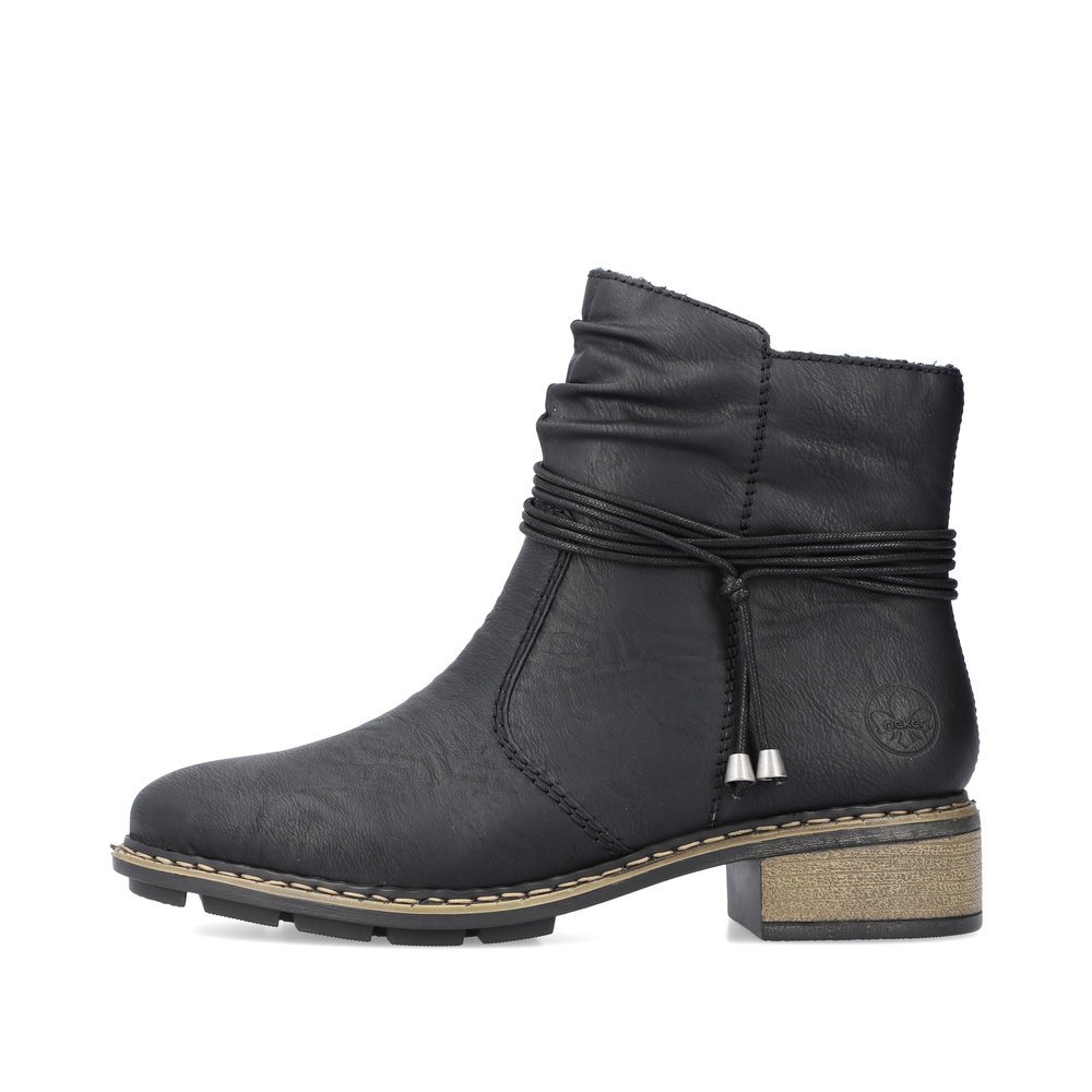 Black Rieker women´s ankle boots 77263-00 with a fashionable cord as well as zipper. Outside of the shoe.