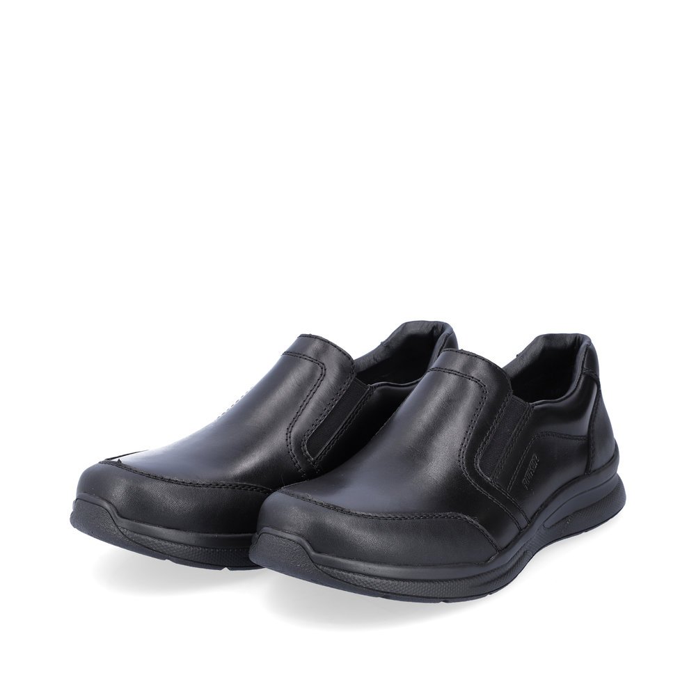 Black Rieker men´s slippers 14850-01 with elastic insert as well as extra width H. Shoes laterally.