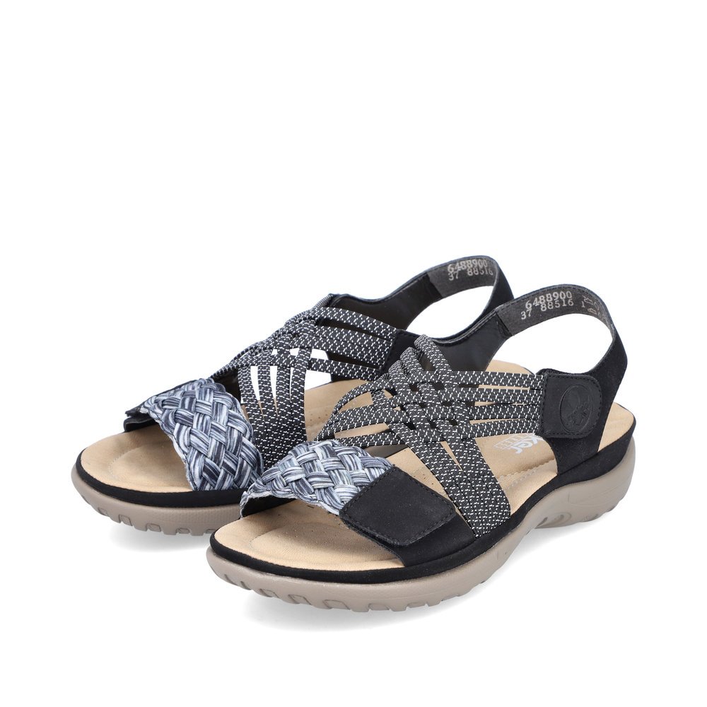 Night black Rieker women´s strap sandals 64889-00 with a hook and loop fastener. Shoes laterally.