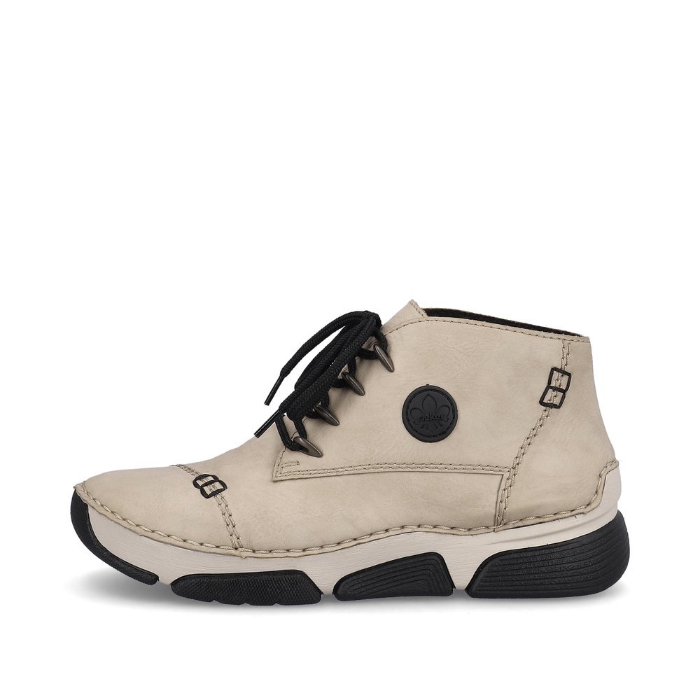 Cream beige Rieker women´s lace-up shoes 45902-60 with a round logo. Outside of the shoe.