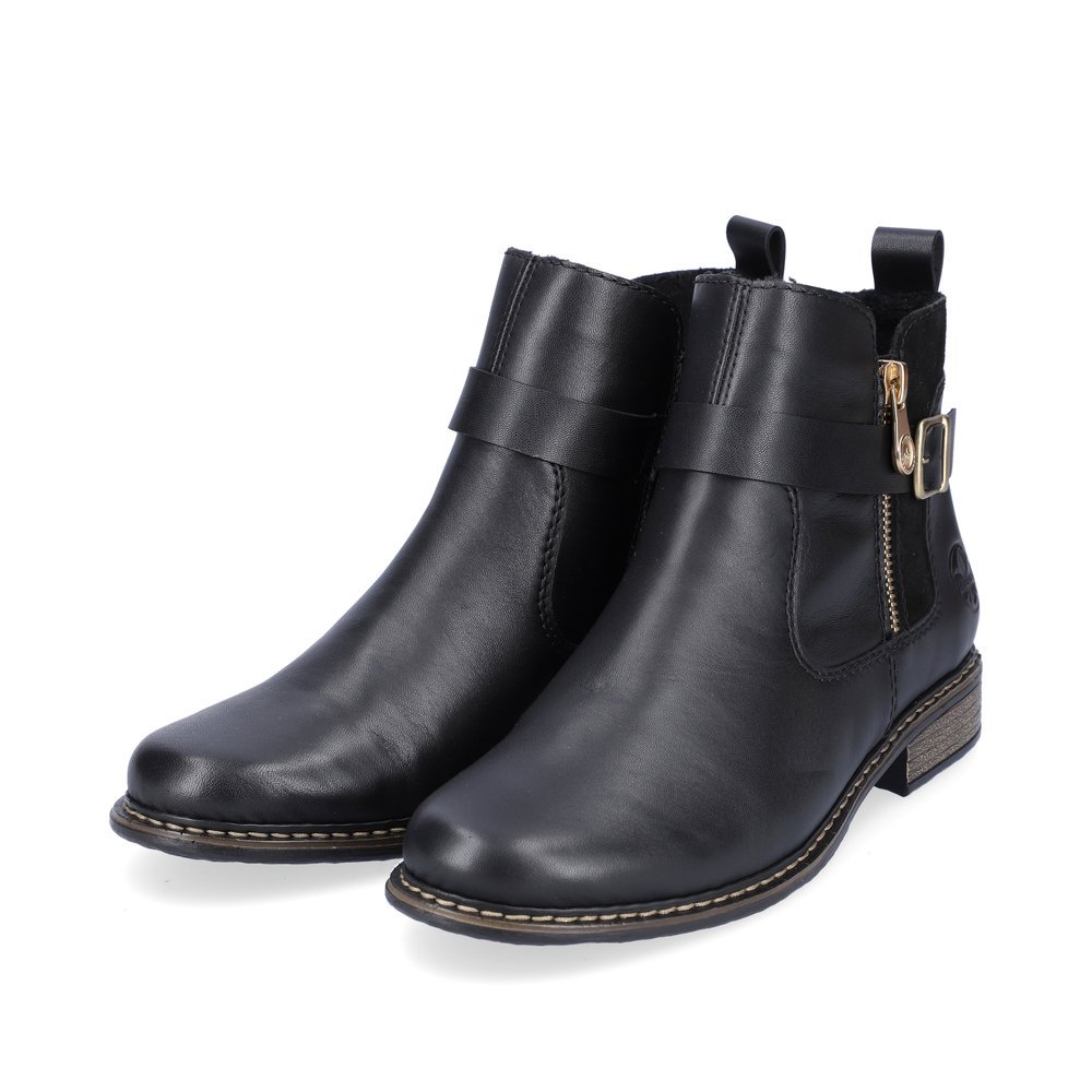 Black Rieker women´s ankle boots Z4959-00 with decorative buckle as well as zipper. Shoes laterally.