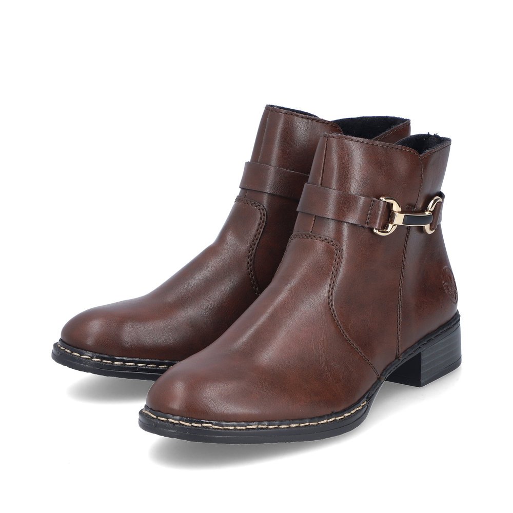 Brown Rieker women´s ankle boots 73487-25 with decorative element as well as zipper. Shoes laterally.