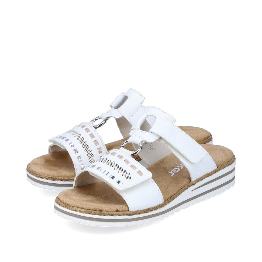 White Rieker women´s mules V0636-80 with a hook and loop fastener. Shoes laterally.