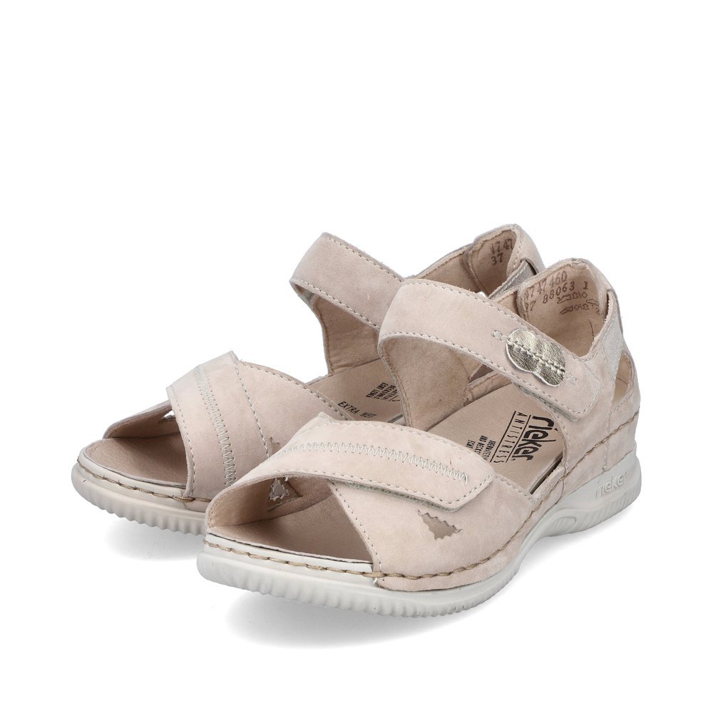 Light beige Rieker women´s strap sandals V7474-60 with a hook and loop fastener. Shoes laterally.