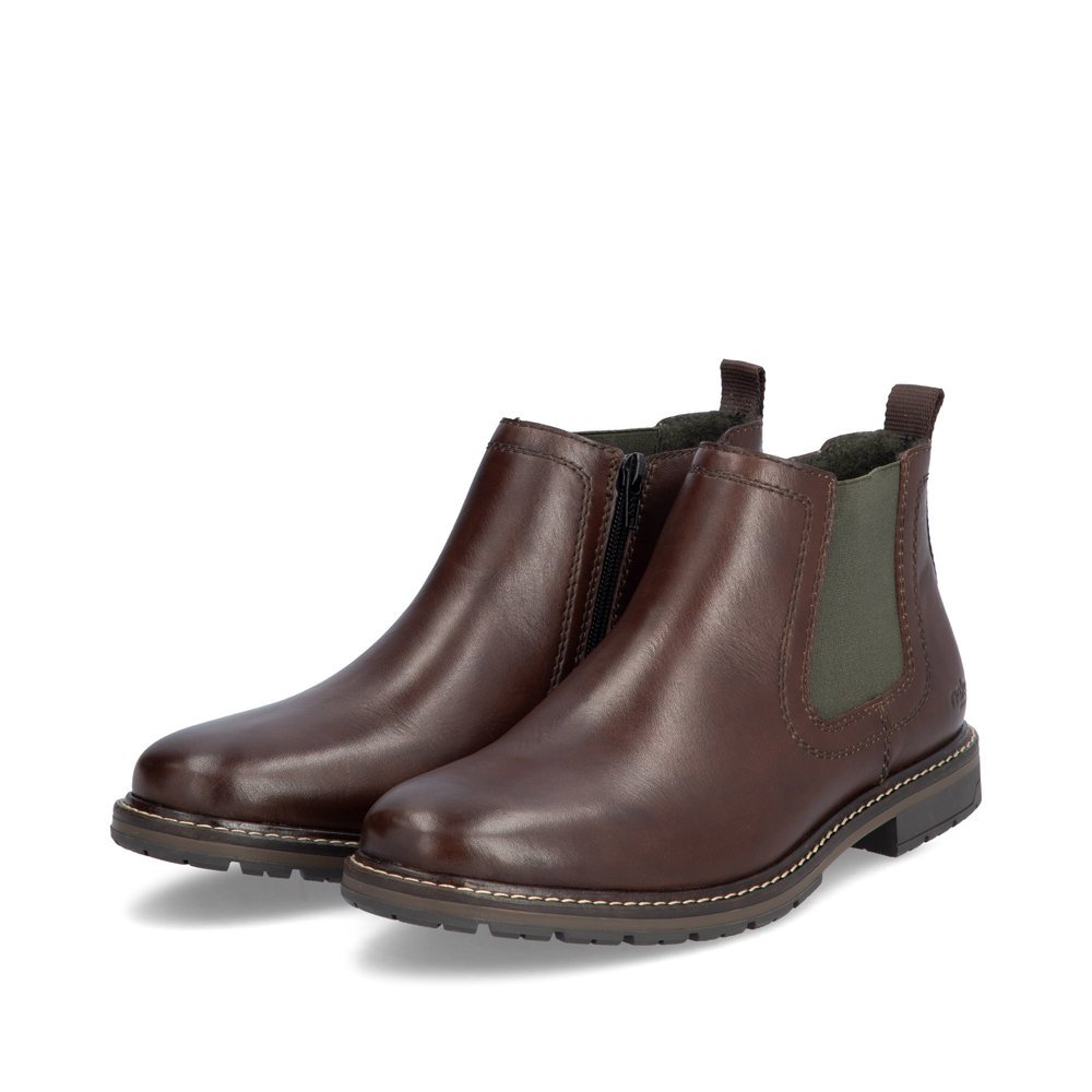 Bottes Chelseas Rieker marron pour homme 13757-25 avec fermeture éclair. Chaussures inclinées sur le côté.