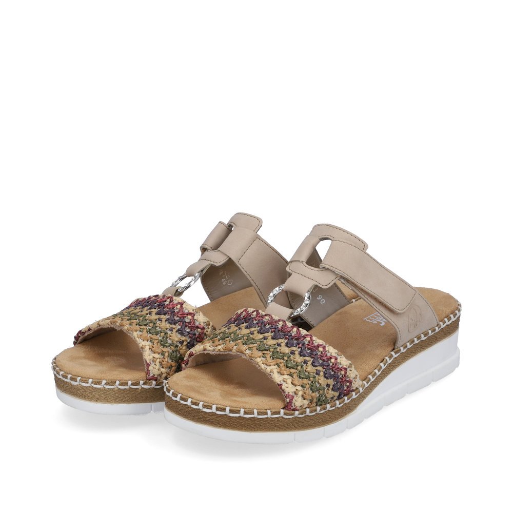 Beige Rieker women´s mules V1243-90 with a hook and loop fastener. Shoes laterally.