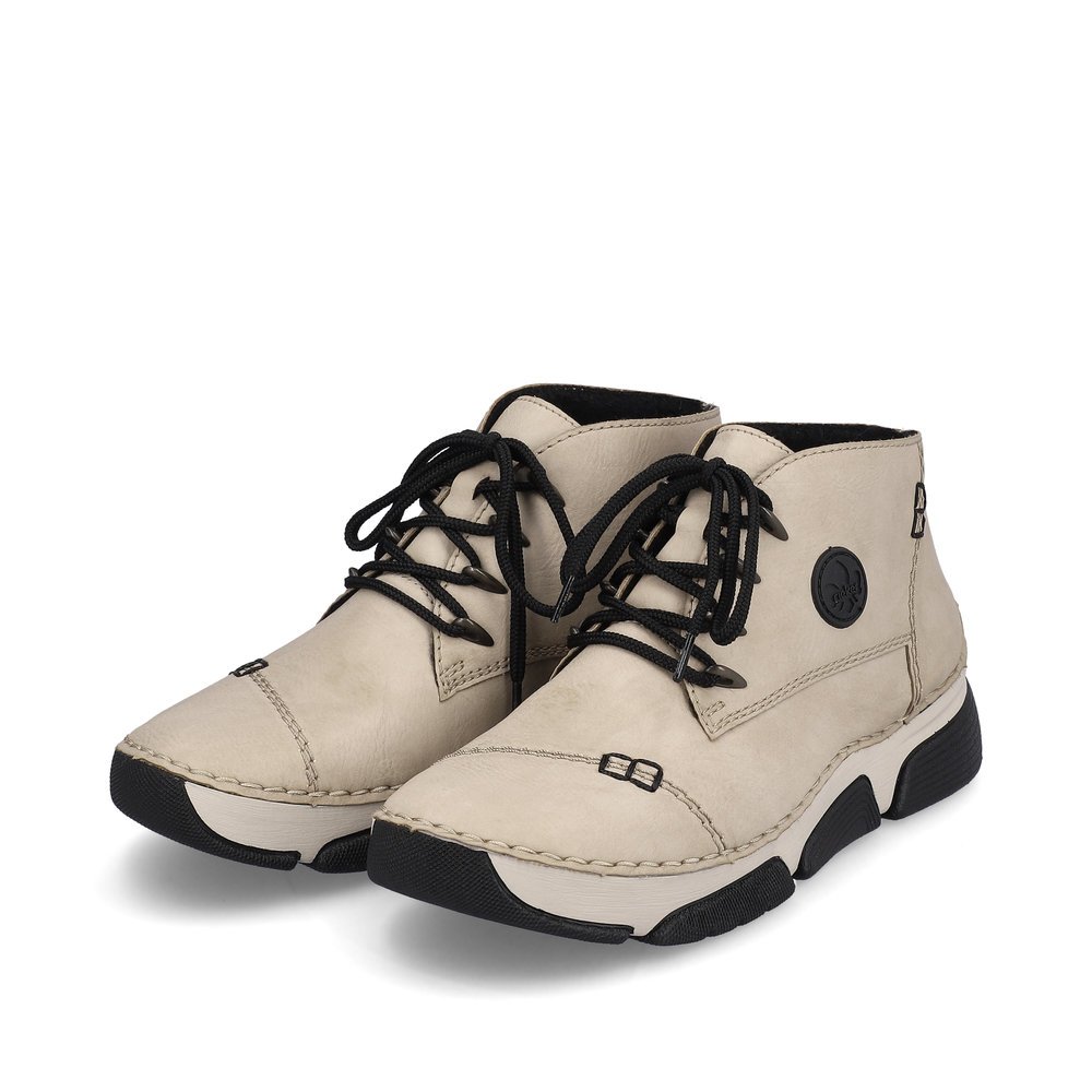 Cream beige Rieker women´s lace-up shoes 45902-60 with a round logo. Shoes laterally.