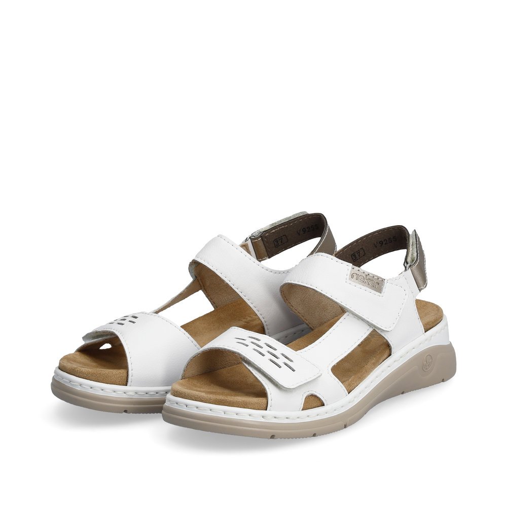 White Rieker women´s strap sandals V9255-80 with a hook and loop fastener. Shoes laterally.
