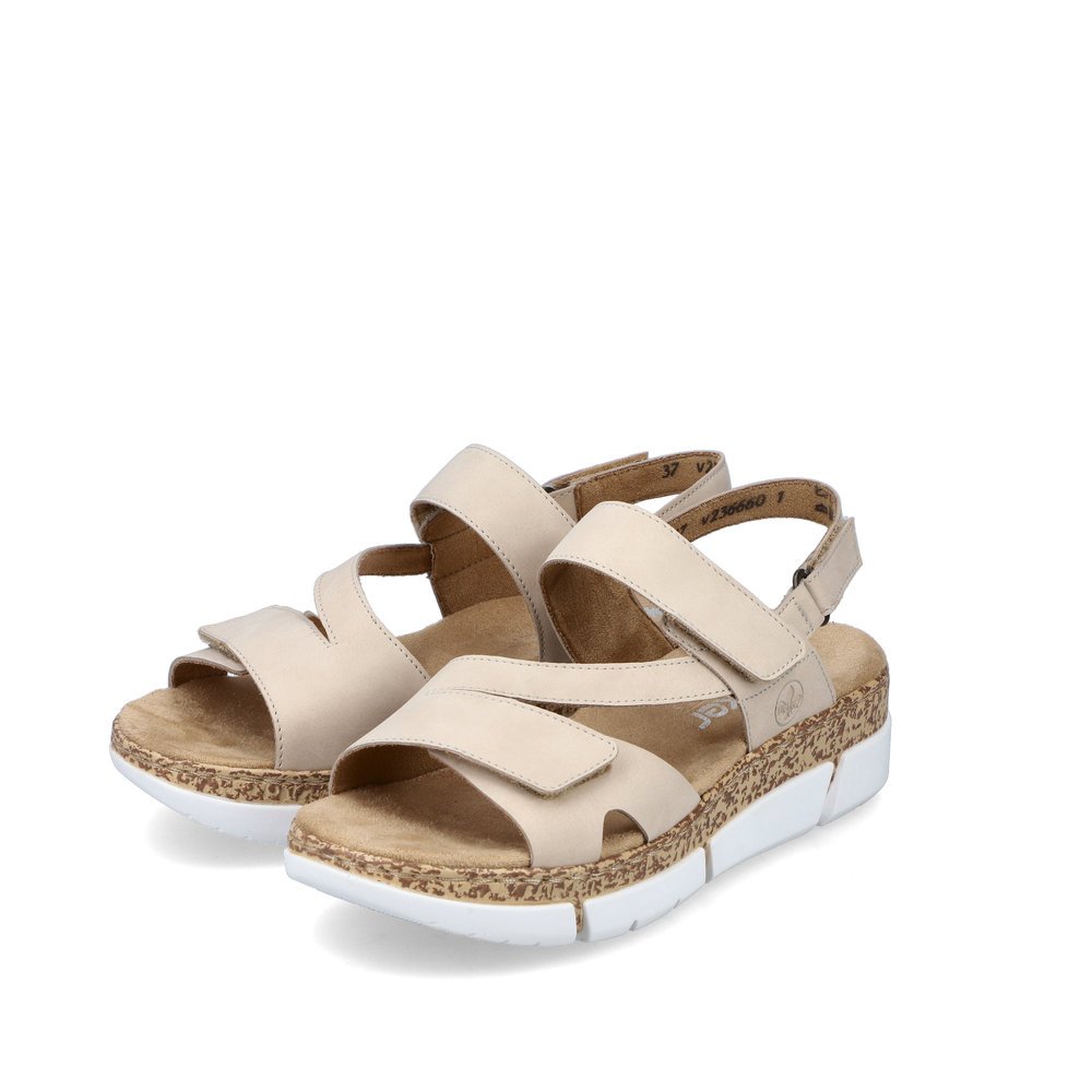 Light beige Rieker women´s strap sandals V2366-60 with a hook and loop fastener. Shoes laterally.