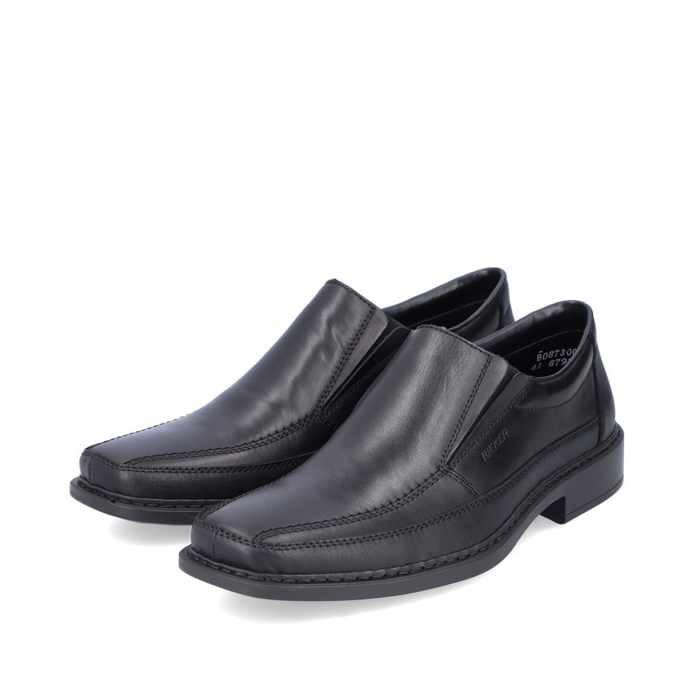 Black Rieker men´s slippers B0873-00 with elastic insert as well as extra width H. Shoes laterally.