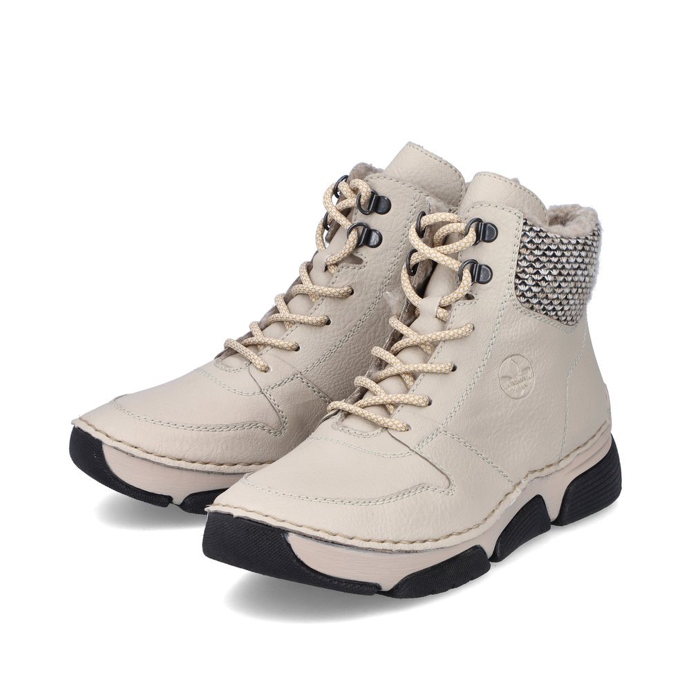 Beige Rieker women´s lace-up boots 45955-60 with a shaft collar as well as a zipper. Shoes laterally.