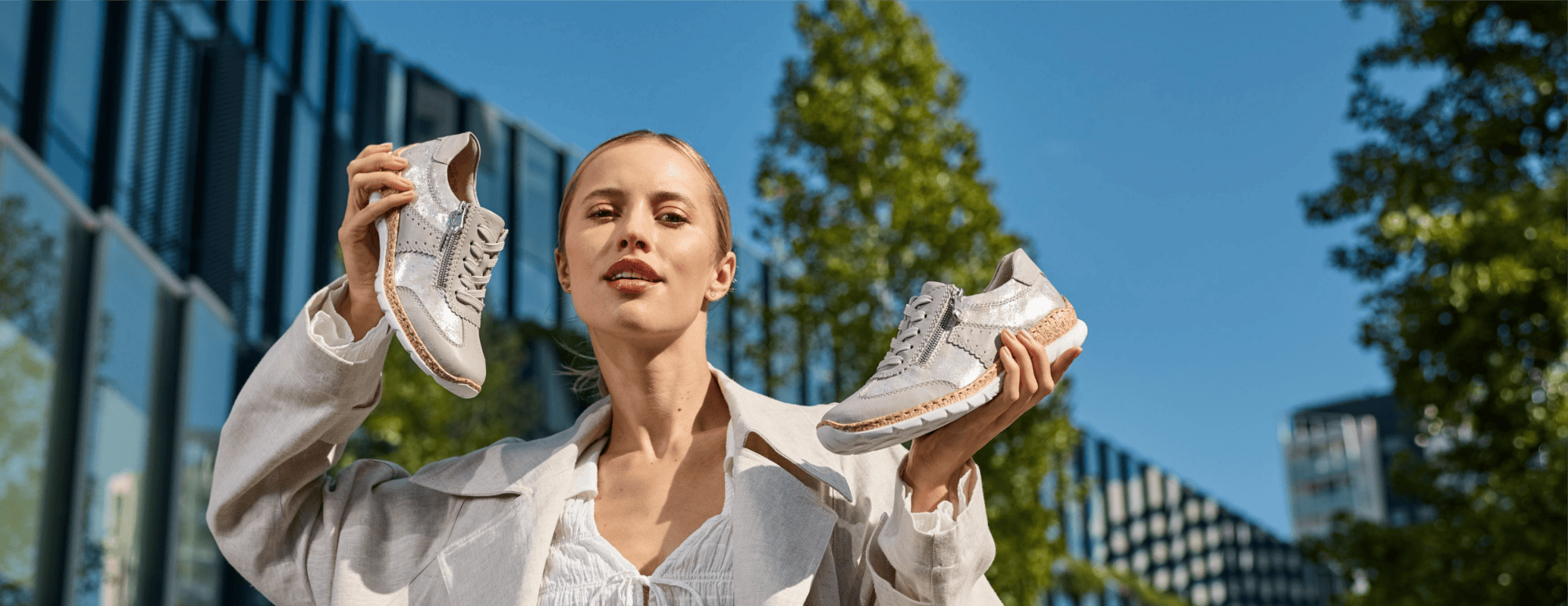 Woman holds Rieker Woman Sneaker in her hands.