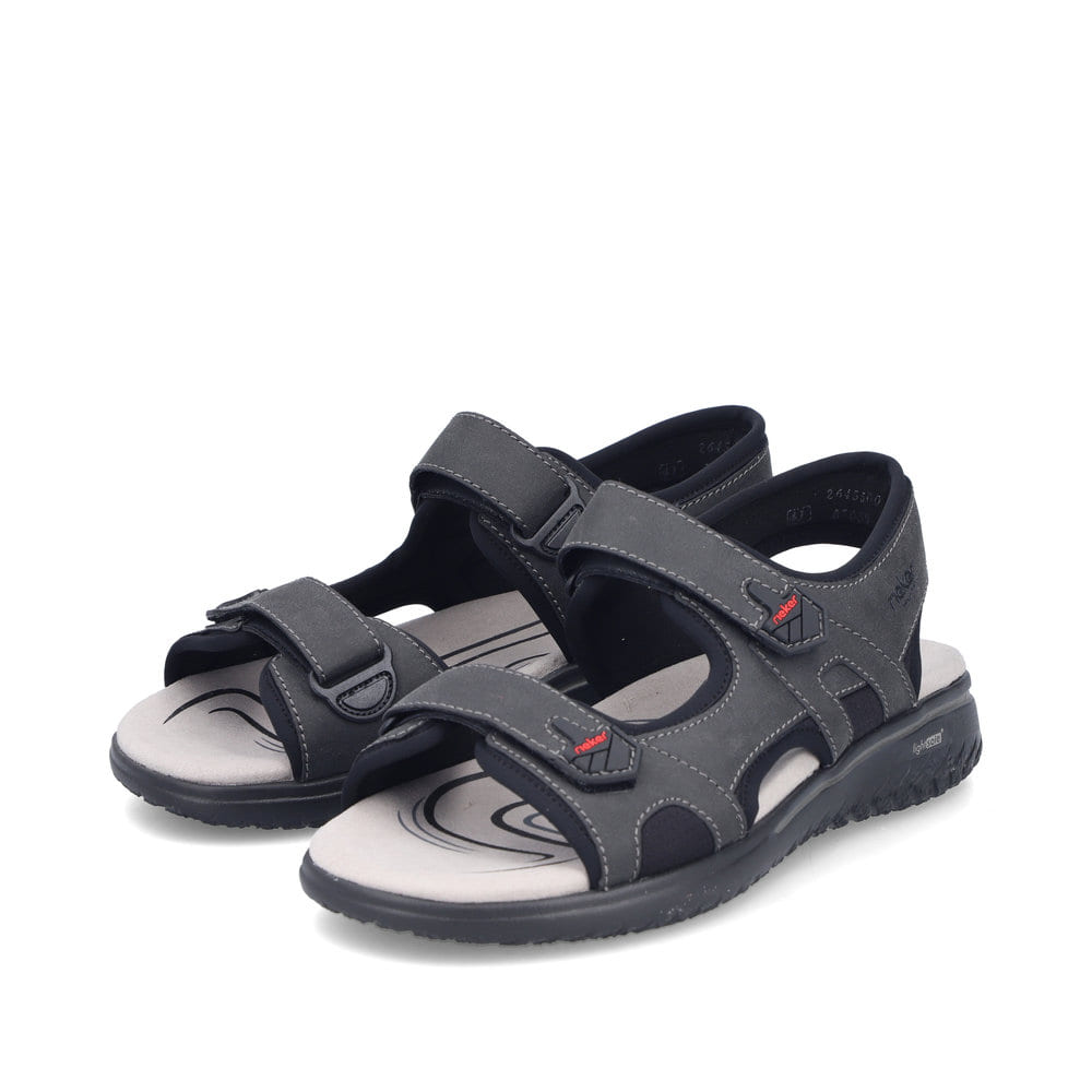 Sandales des randonnée Rieker noires pour homme 26455-00. Chaussures inclinées sur le côté.