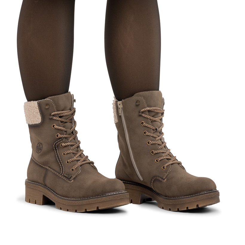 Braun-beige Rieker Damen Schnürstiefel Y8119-25 mit Teddyfell-Kragen. Schuh am Fuß.