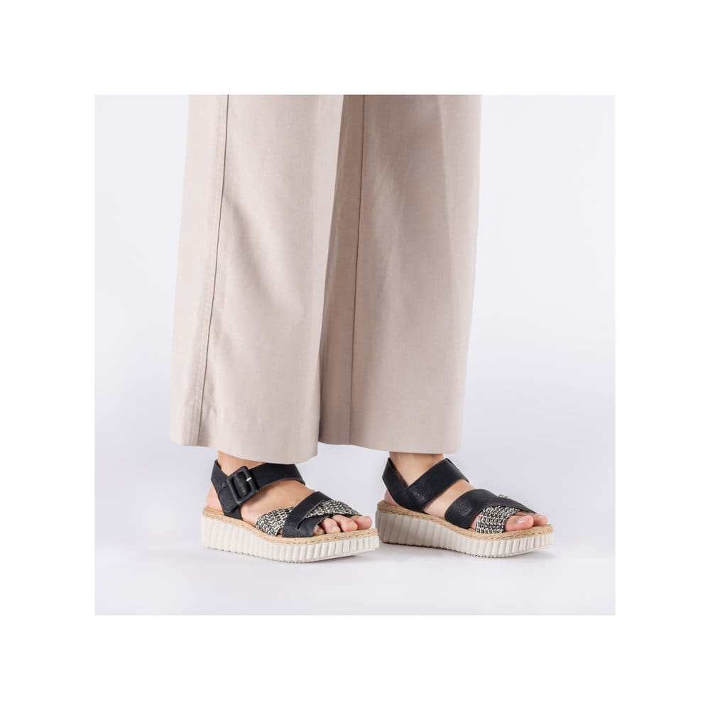 Schwarze Rieker Keilsandaletten 69269-00 mit trendiger Schnalle. Schuh am Fuß.