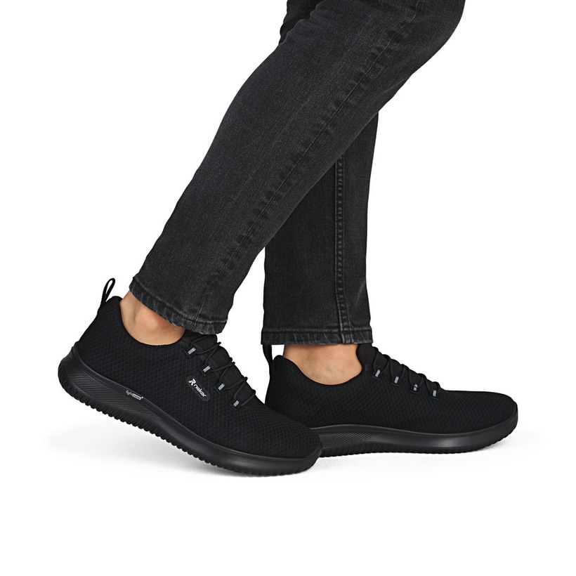 Schwarze Rieker Herren Slipper B9655-00 mit einem Gummizug sowie Komfortweite G. Schuh am Fuß.