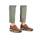 Braune Rieker Herren Slipper 08067-24 mit Klettverschluss sowie Komfortweite G. Schuh am Fuß.