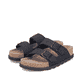 Mules Rieker noires pour femme V3190-01 en cuir velours avec boucles. Chaussures inclinées sur le côté.