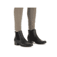 
Mitternachtsschwarze Rieker Damen Chelsea Boots 78600-01 mit einer Profilsohle. Schuh am Fuß