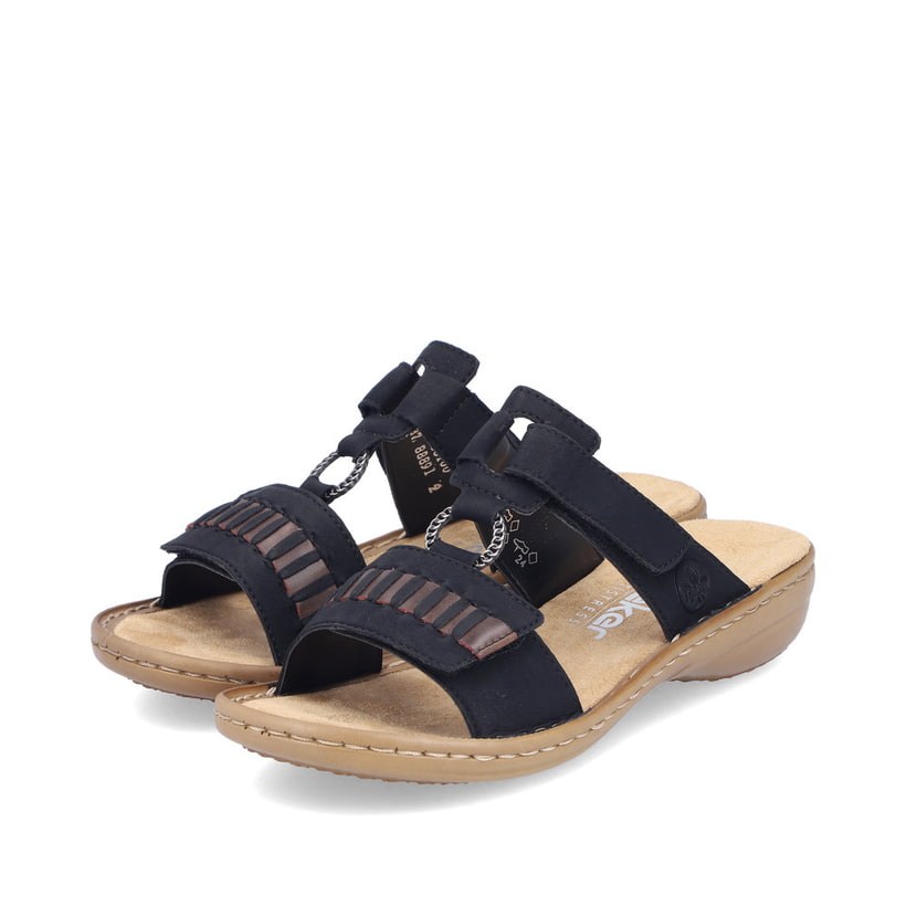 Mules Rieker noires pour femme 60881-00 avec fermeture velcro. Chaussures inclinées sur le côté.