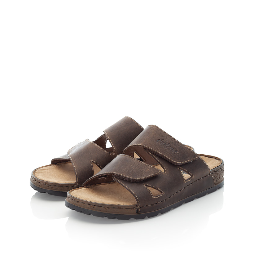 Tabakbraune Rieker Herren Pantoletten 25691-25 mit einem Klettverschluss. Schuhpaar seitlich schräg.