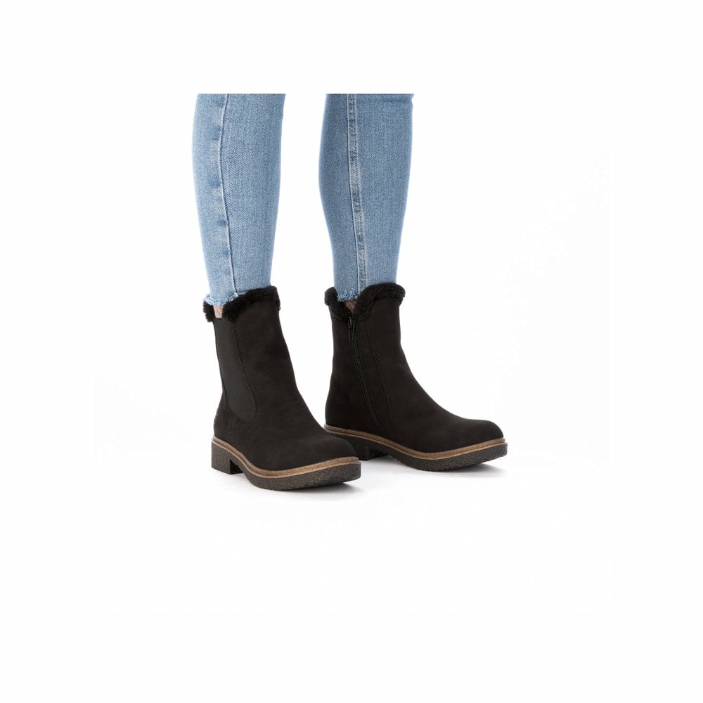 Schwarze Rieker Damen Chelsea Boots Z5076-00 mit Fellschaftrand. Schuh am Fuß.