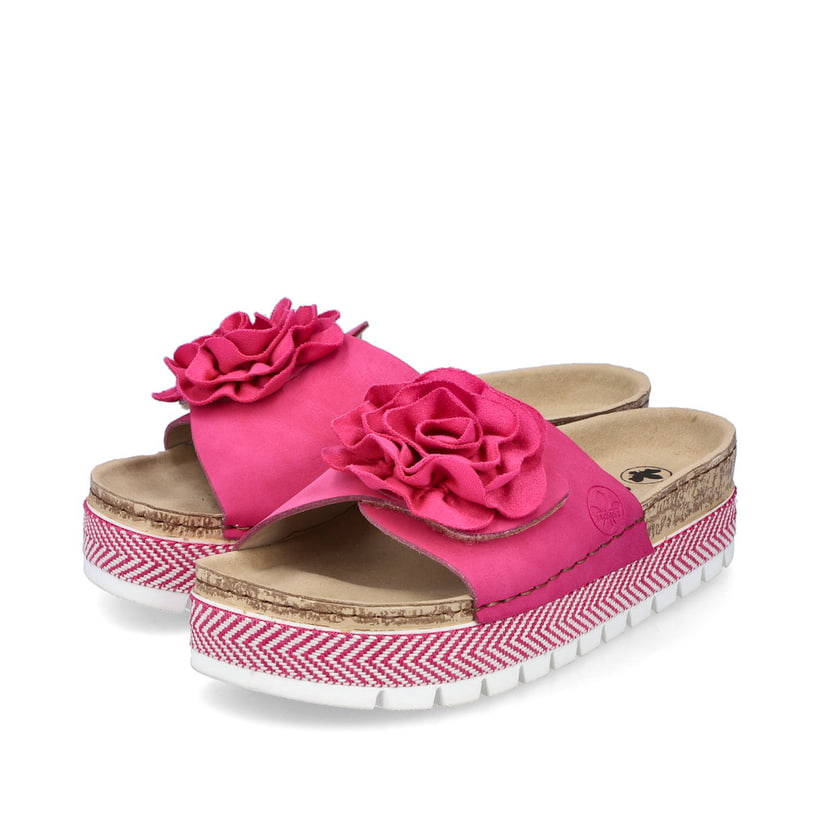 Mules Rieker roses pour femme 69562-31 avec fleur décorative. Chaussures inclinées sur le côté.
